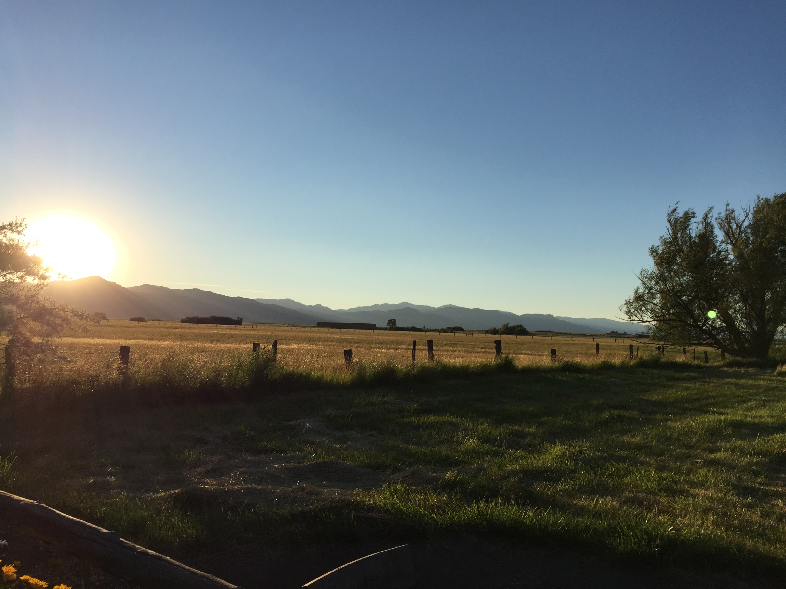 sun going down across the fields as seen from ranch house